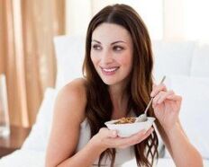 The girl eats buckwheat